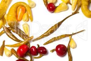 Mix of hot marinated peppers on white background