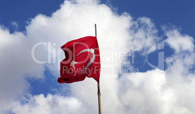 Turkish flag on flagpole waving in wind