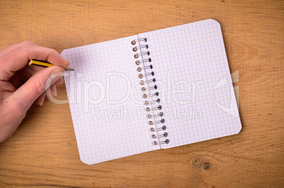 Male hand with notebook