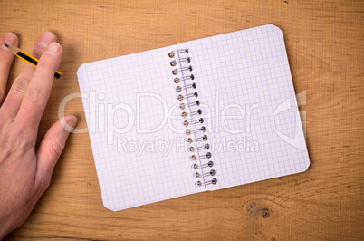 Male hnad with pen and notebook