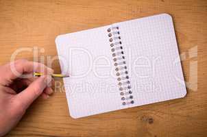 Male hand with a notebook