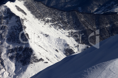 View from off-piste slope on snowy canyon