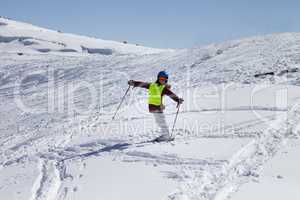 Little skier on ski slope with new fallen snow at sun day