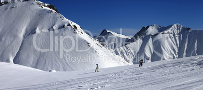 Panoramic view of snowboarders downhill on off piste slope after