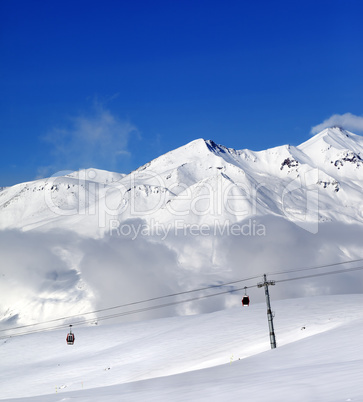 Winter snowy mountains and cable car at nice day