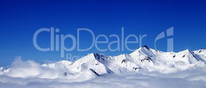 Panoramic view of winter snowy mountains under clouds at nice da