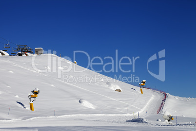 Ski slope with snowmaking at sun day