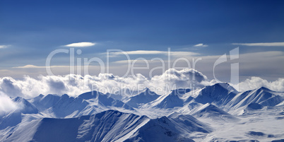 Panoramic view on cloudy mountains in evening