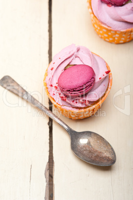 pink berry cream cupcake with macaroon on top