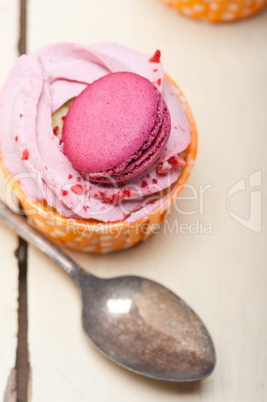 pink berry cream cupcake with macaroon on top