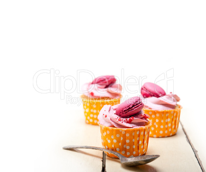 pink berry cream cupcake with macaroon on top