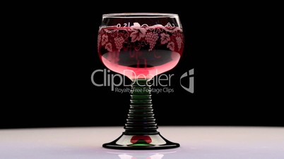 Close-up of turning beautiful glass of pink wine
