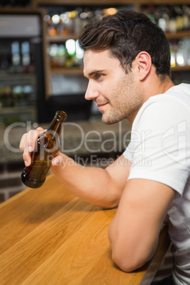 Handsome man holding a bottle of beer