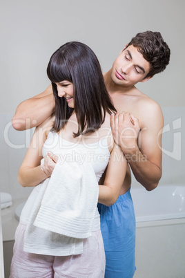 Man applying moisturizer on womans neck