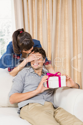 Young man receiving a surprise gift