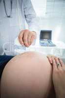Pregnant woman receiving ultrasound treatment