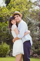 Young couple cuddling outdoors