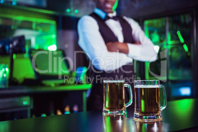 Two glasses of beer on bar counter