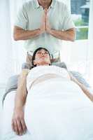 Pregnant woman receiving a massage from masseur