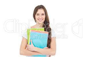 Portrait of smiling female college student holding books