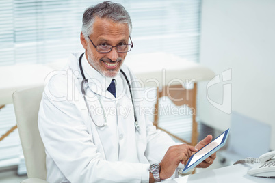 Doctor using digital tablet at clinic