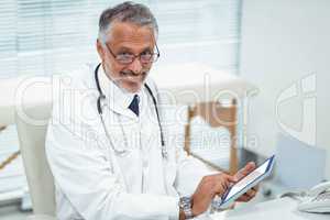 Doctor using digital tablet at clinic