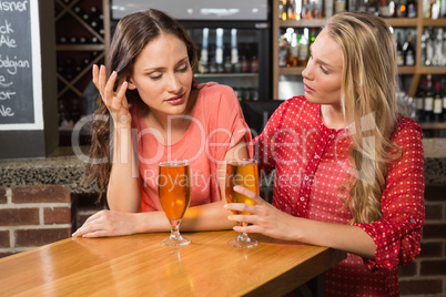 Cute friends having a glass of beer