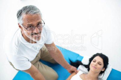 Doctor giving physiotherapy to pregnant woman