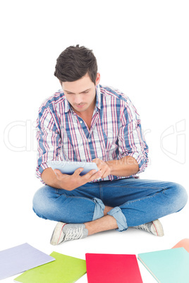 Man using a tablet while sitting on the floor