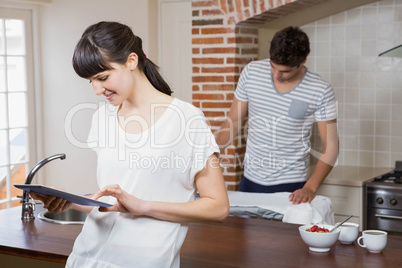 Woman using tablet in kitchen