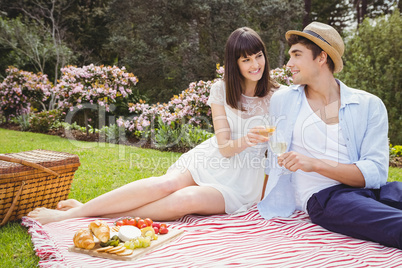 Young couple having glass of wine in garden