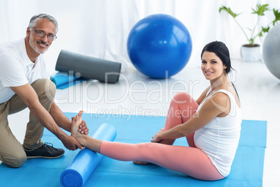 Doctor giving physiotherapy to pregnant woman