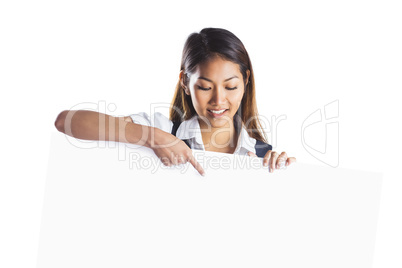 Smiling businesswoman pointing a white poster