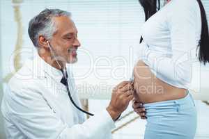 Doctor examining pregnant woman