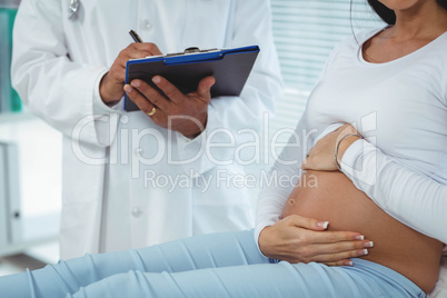 Pregnant woman interacting with doctor