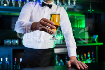 Bartender serving a glass of beer