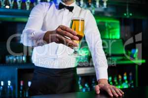 Bartender serving a glass of beer