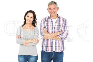 Smiling couple with crossed arms looking the camera