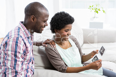 Pregnant couple looking at ultrasound scan