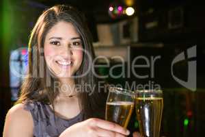 Portrait of beautiful woman toasting her beer glass