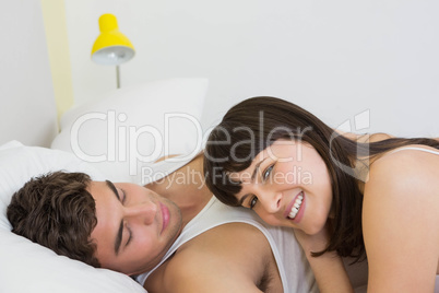 Young couple embracing on bed