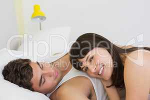 Young couple embracing on bed