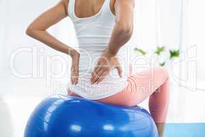 Pregnant woman exercising on exercise ball