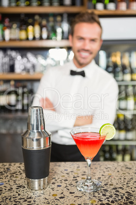Handsome bar tender standing behind his counter