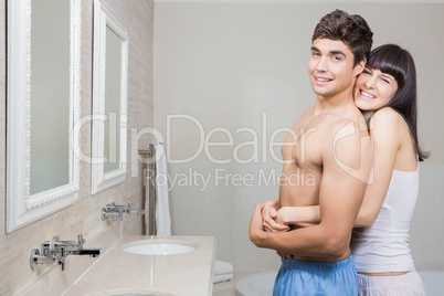 Young couple embracing in bathroom