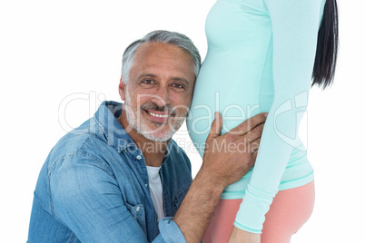 Man listening to pregnant womans stomach