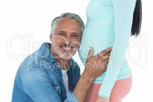 Man listening to pregnant womans stomach