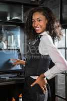 Happy barmaid preparing a bill