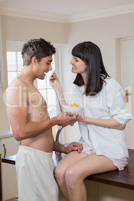 Woman feeding fruits to man