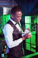 Smiling bartender cleaning a glass